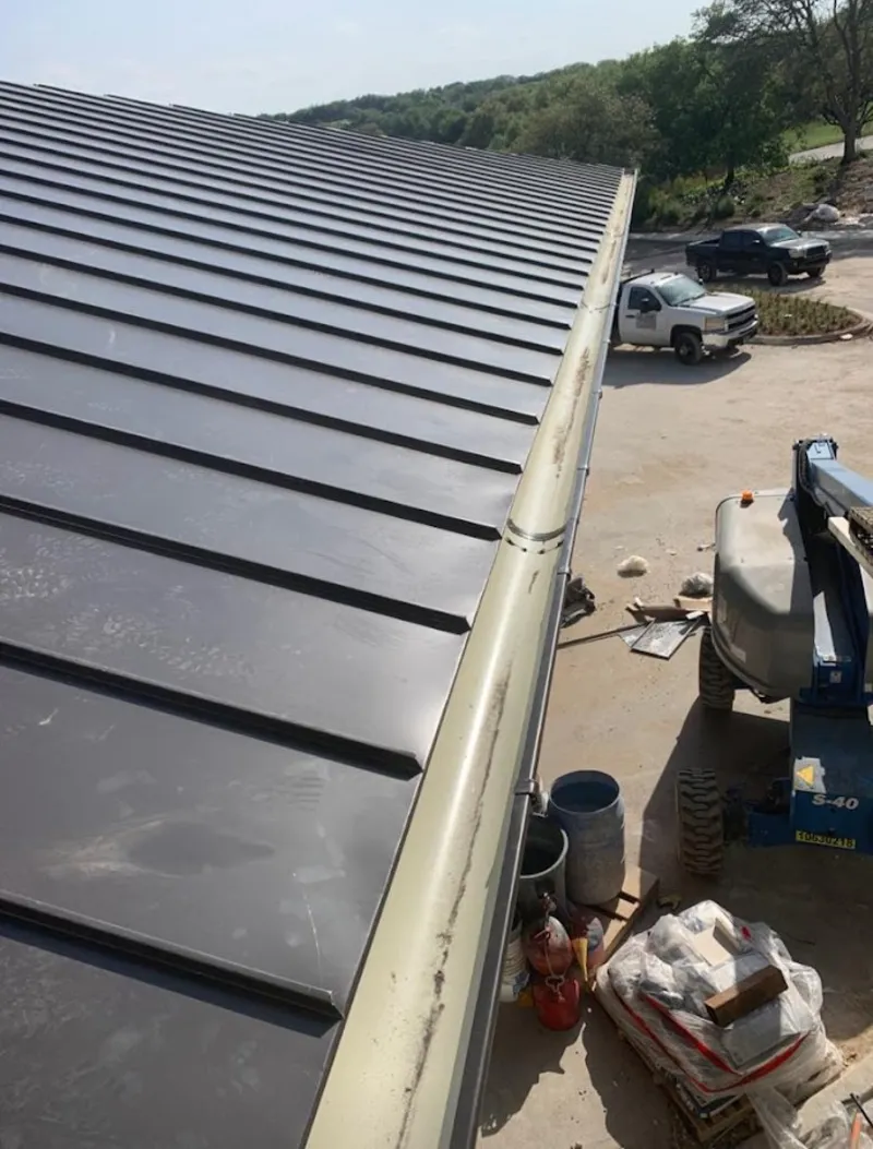 Standing seam panel and gutter detail on a metal roofing jobsite in Fort Myers